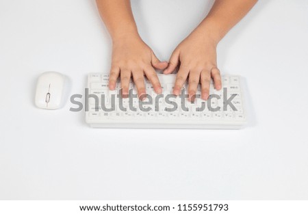 Top view two hands of young boy practicing use the keyboard and mouse during e-learning in class on white isolated background / modern technology back to school concept
