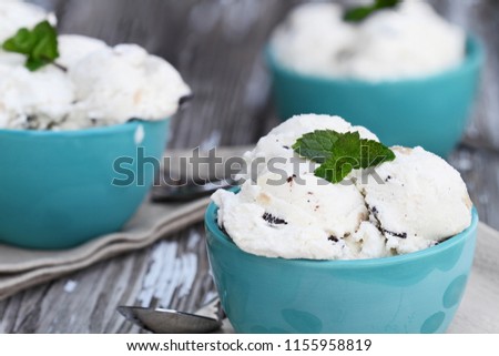 Three bowls of chocolate chip cookie dough ice cream. Extreme shallow depth of field with selective focus on bowl in front.