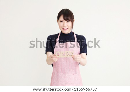 Young Asian woman entrepreneur showing open sign