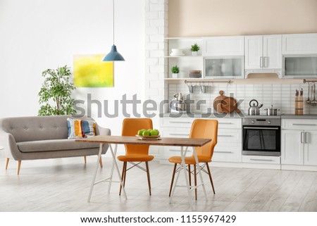 Stylish apartment interior with kitchen furniture and sofa Royalty-Free Stock Photo #1155967429
