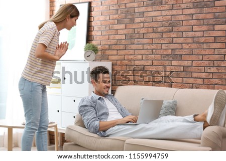 Lazy husband quarrelling with hardworking wife at home