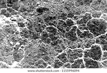 Dark dried and cracked earth background texture, black and white photo