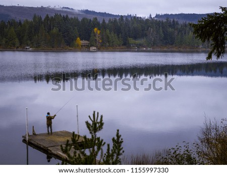 Man Fishing in Lake in Early Morning