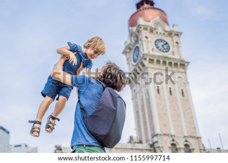 Dad and son on background of Sultan Abdul Samad Building in Kuala Lumpur, Malaysia. Traveling with children concept