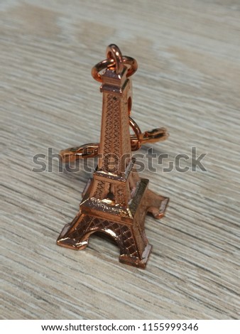 a bronze key ring of the Eiffel Tower in France