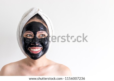 An asian woman using activated black charcoal and yogurt mask on her face for deep cleaning the skin, beauty and skincare product for acne and blackheads removal