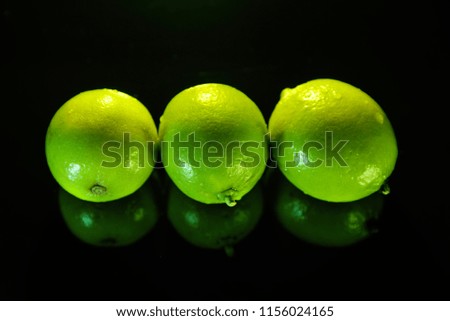 Three limes on a black background