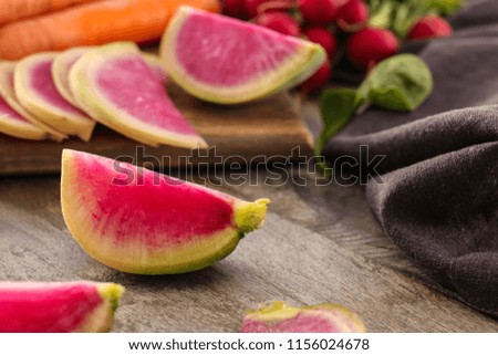 Fresh sliced radish on wooden table