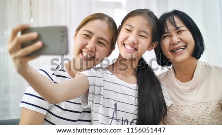Happy Asian family take selfie photo shot together by smartphone, Multi generation of Asian female