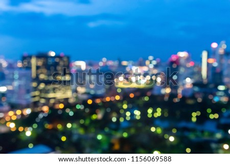 Abstract urban night light bokeh defocused of city and the office building. City and tower blurred background on twilight color sky. Night light of real estate as concept.