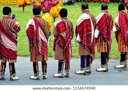 Bhutanese men in their best traditional attire. Bhutanese are fond of their unique dress which they proudly wear at all times. Shown in the picture is Bhutanese clergy men in their formal dress. Royalty-Free Stock Photo #1156074940