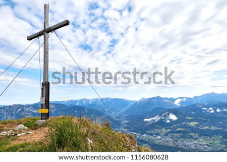 A wood cross on top of the mountain Kalmberg and rays of the sun. Beautiful landscape.  Salzkammergut region, Bad Goisern, Austria.