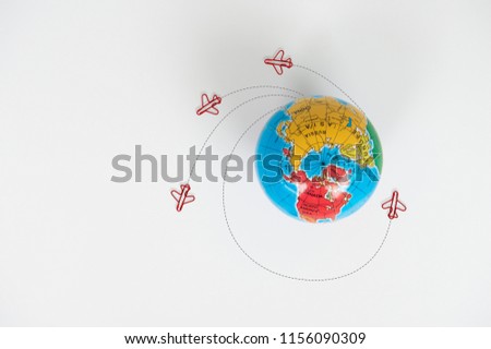Globe model with air plane paper clip flying circle  on the white background for transport and travel concept
