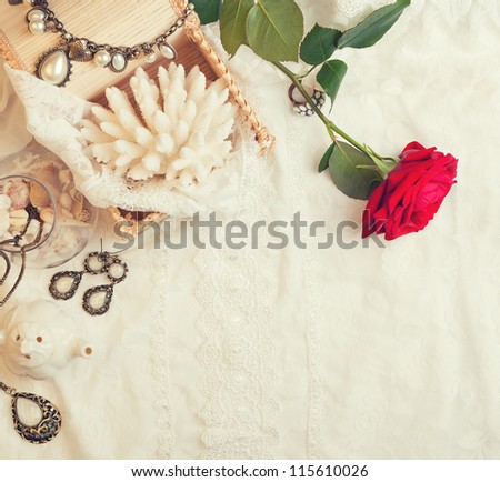 Vintage background with rose and jewelry