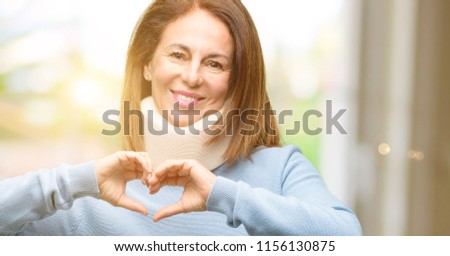 Injured woman wearing neck brace collar happy showing love with hands in heart shape expressing healthy and marriage symbol