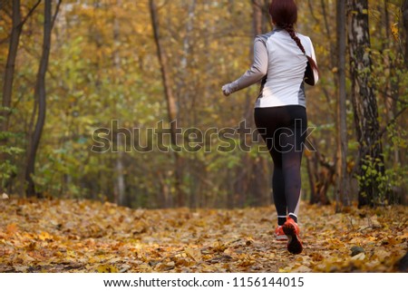 Photo from back of girl in sports clothes on run
