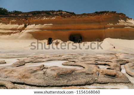 Salt ponds and entrances in the rock dunes near Qbajjar in Gozo, Malta