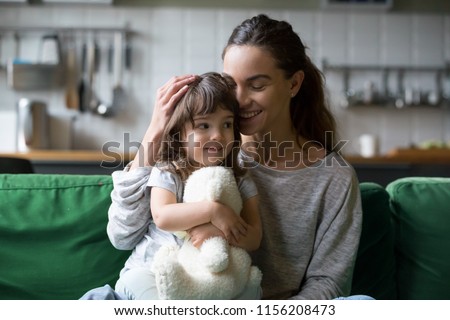 Happy single mother hugging cute daughter showing care support, young smiling mom or sister embracing girl feeling gratitude love, mum and kid sincere warm relations, mommy and child family concept Royalty-Free Stock Photo #1156208473