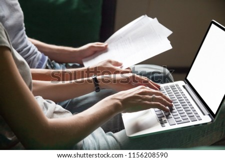 Close up of couple searching online information about legal document details with laptop, family studying important contract terms and conditions typing filling internet application form on website Royalty-Free Stock Photo #1156208590