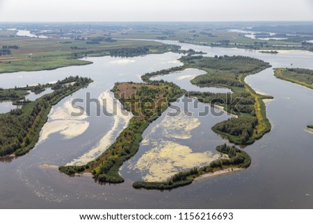 Aerial view estuary Dutch river IJssel with small islands and wetlands in lake Ketelmeer Royalty-Free Stock Photo #1156216693