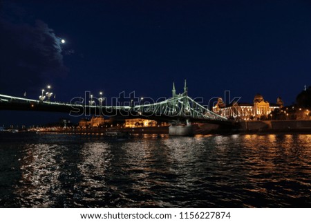 Panoramic views of night bridges through Danube with illumination.