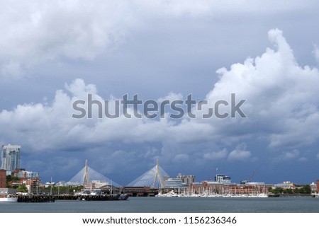 Clouds, ocean, city, and bridge. Boston.