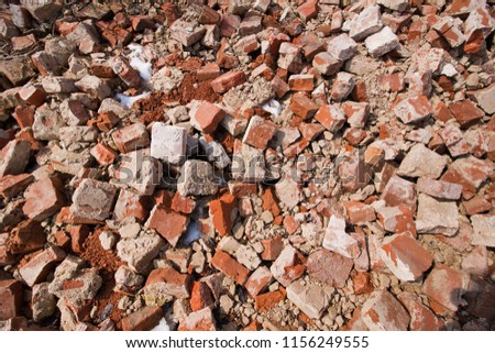 Close up view of old broken red bricks with some conrete on them, lying on the ground, on a sunny day, rough abstract background surface texture photo