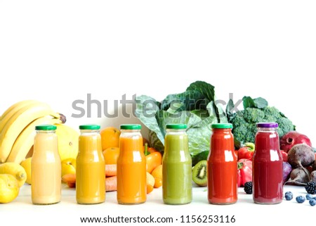 Composition of healthy colorful vegetable juices and smoothies with chia and flax seeds in glass bottles, set vegetables and fruits on the white background, copy space