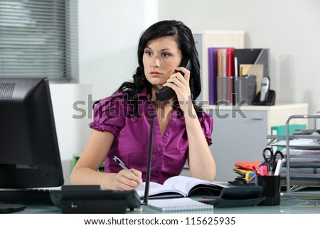 Busy receptionist Royalty-Free Stock Photo #115625935