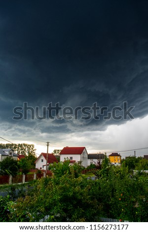 Thunderstorm clouds over a small town. Storm funnel clouds.