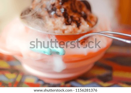 Chocolate Ice Cream on Snowflake ice in colorful bowl, with lava smoke from dry ice.