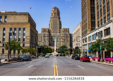 Buffalo City hall and Niagara Square  ( State of New York) view from court Street during day time from the middle of the road. Blue sky with almost no clouds and no cars driving by.