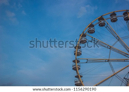 ferris wheel with lights carnival concept on blue sky background and empty space for wallpaper copy or text