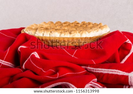 apple pie on a red tablecloth and white background