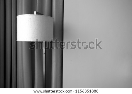 Black and white scene of room lamp in front of curtain with copy space, room interior, peace and vintage style decoration
