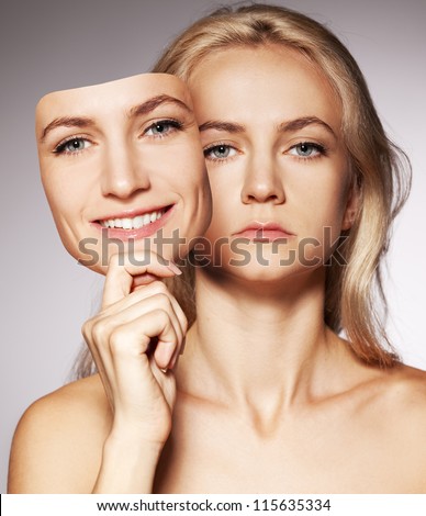 Woman hiding under the happy mask.  Hypocritical,  insincere, two-faced female Royalty-Free Stock Photo #115635334
