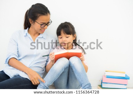 family education. mother woman and children in library reading books