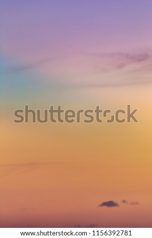 A picture with an up-close view of colorful clouds during a sunset.