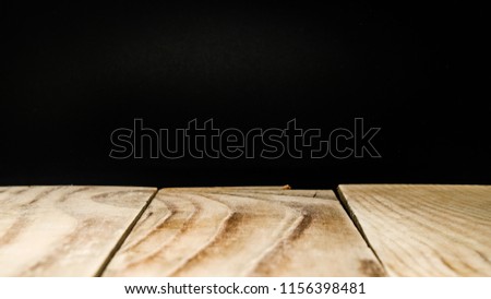 Wooden table on blackboard background.old wood perspective for advertise product on display.