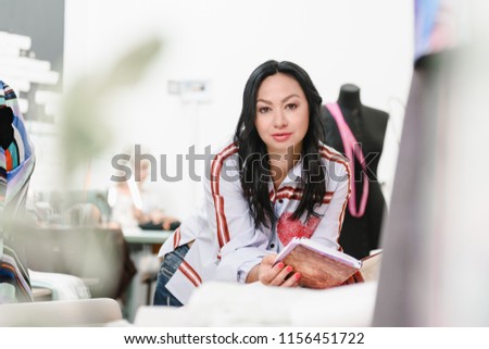 middle age talented female designer looking at camera