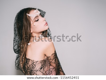 Woman with horns and thorns wears black veil fantasy creature. Mystic fairy tail character. Girl with thorns as devil dragon magical creature. Girl with fantasy style make up. Halloween ideas concept.