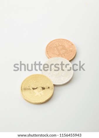 Three Bitcoins Coins on white background, studio shot