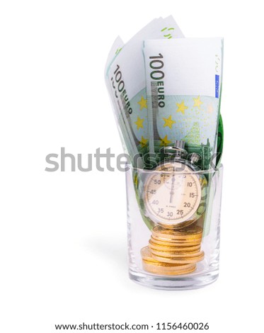 Bitcoins on a pile of one hundred euros and a bulb clock on empy glass