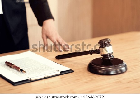 Legal counsel presents to the client a signed contract with gavel and legal law. justice and lawyer concept
