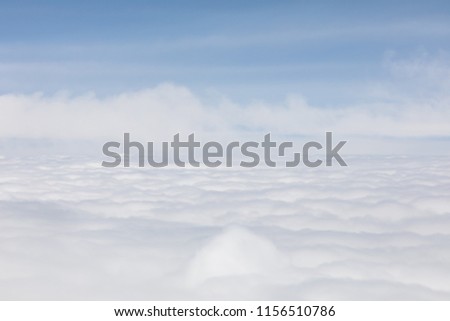 Group of white fluffy clouds, view of the plane