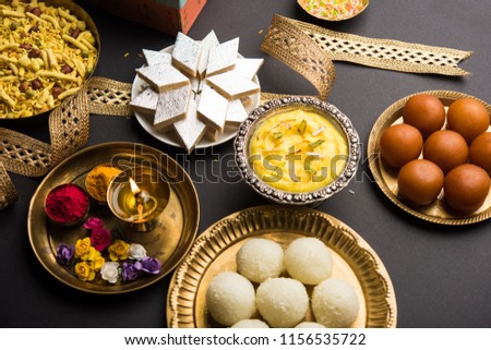 Raksha bandhan greetings : Sweet food like Gulab Jamun, Rasgulla, Shrikhand, Bundi Laddu, Kaju Katli and farsan with Pooja thali for Rakhi Festival Celebration
 Royalty-Free Stock Photo #1156535722