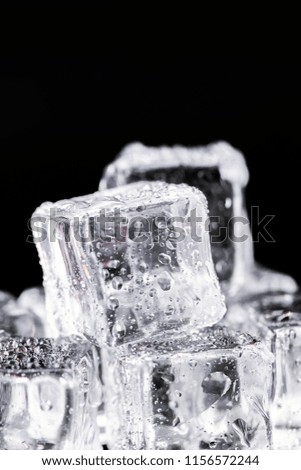 Three ice cubes on black background.