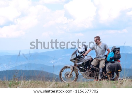 Motorcyclist man and Adventure Motorbike with beautiful mountains. Motorcycle trip. off road Traveling, Lifestyle Travel vacations sport outdoor concept.