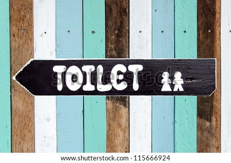 Toilet signs on the old wood wall background