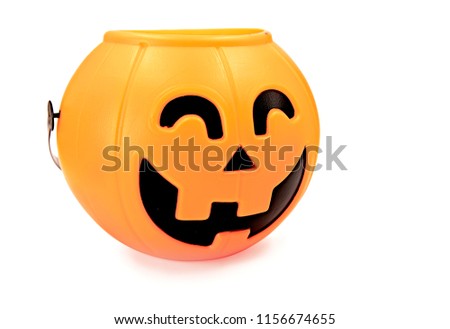 spooky halloween plastic pumpkin for trick or trating isolated on white background with clipping path